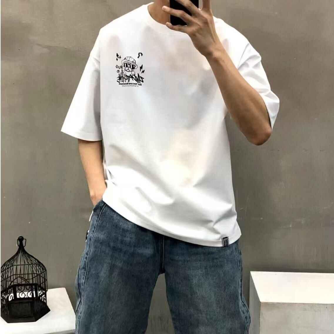 Beige oversized t-shirt with pug crayon graphic, styled with blue jeans, casual streetwear