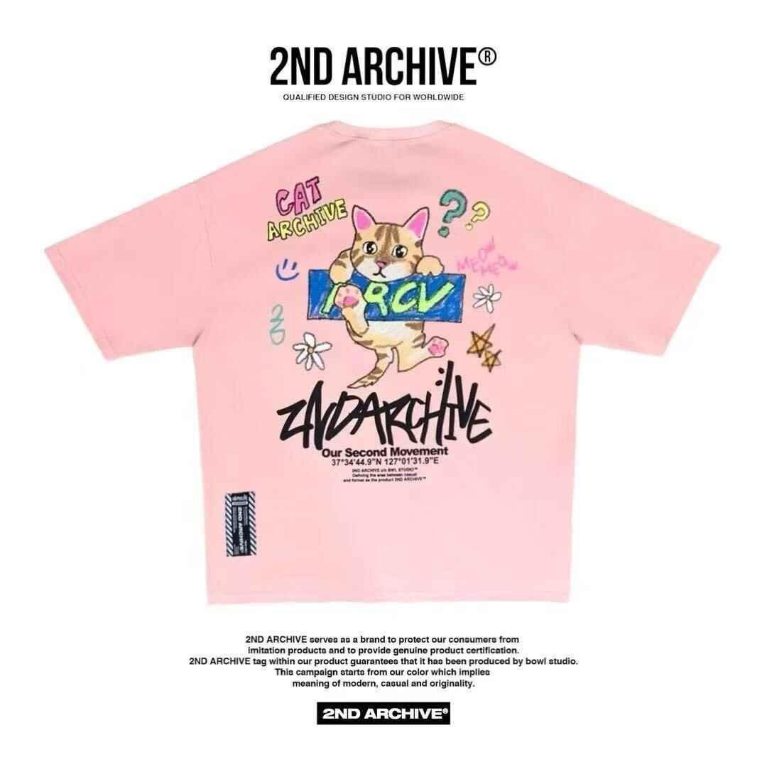 Pink graphic t-shirt with cartoon cat, colorful doodles, and bold text on back, casual streetwear