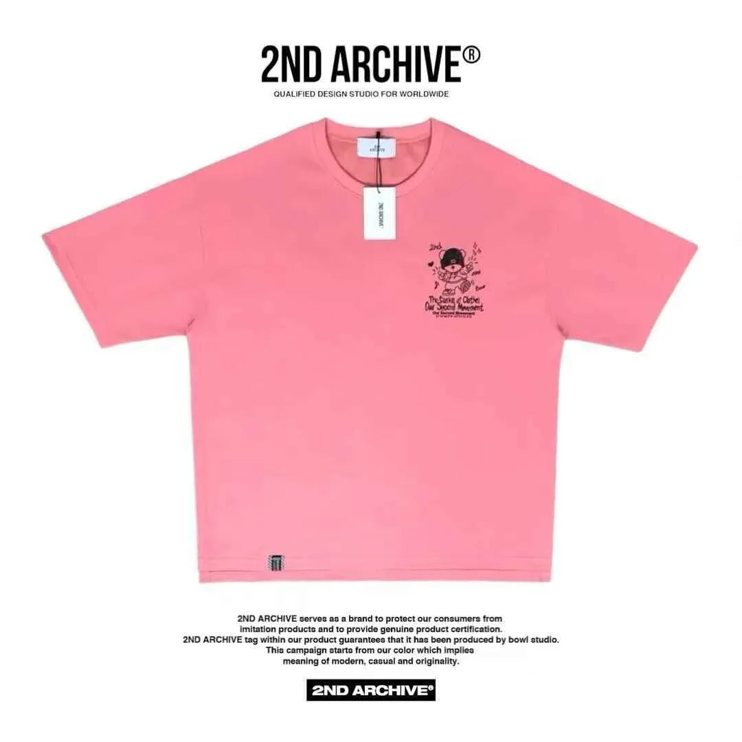 Pink short-sleeve t-shirt with teddy bear and text graphic on chest, 2ND ARCHIVE tag attached.