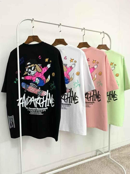 Colorful graphic tees with cartoon skateboarding dog print hanging on rack, streetwear fashion
