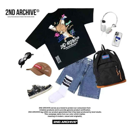 Flat lay of black graphic t-shirt, denim shorts, black backpack, sneakers, cap, socks, sunglasses, headphones, and smartphone with card holder, casual streetwear ensemble.