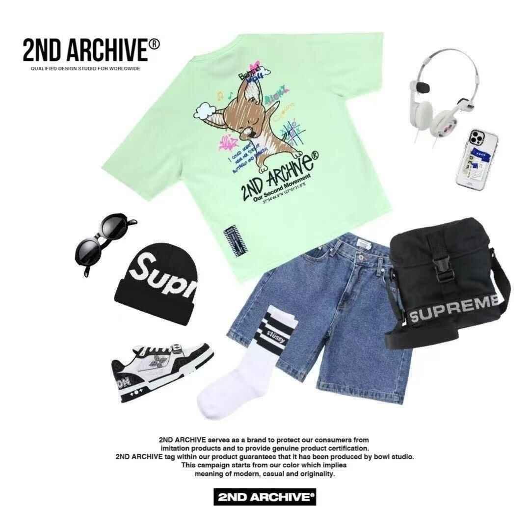 Trendy flat lay of mint green fox graphic t-shirt, denim shorts, black Supreme beanie, sneakers, crossbody bag, headphones, sunglasses, and smartphone.