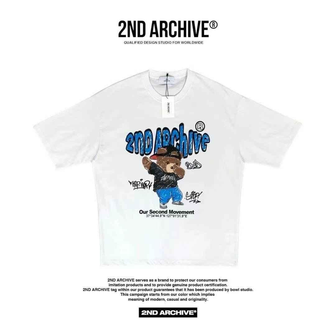 White graphic t-shirt with 2ND ARCHIVE logo and cartoon bear in streetwear, casual fashion style.
