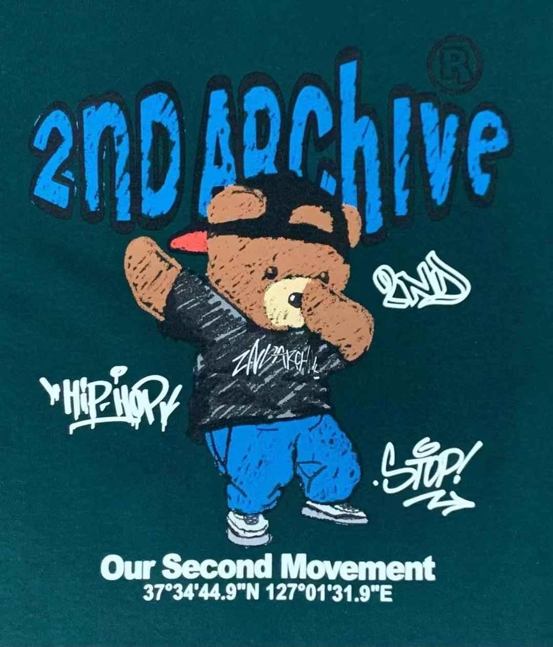 Green t-shirt with cartoon bear in streetwear, graffiti text, and &
